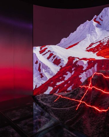 detail of a screen behind a miniature mountain illuminated with lasers