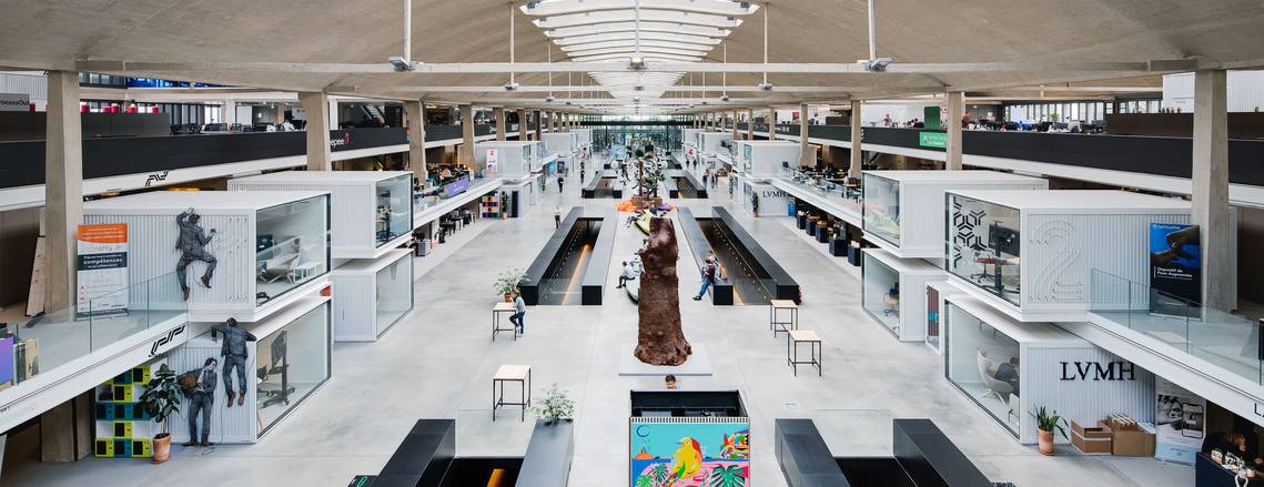 station F interior, white containers, wide angle, central view, concrete, LVMH logo, street art, architecture