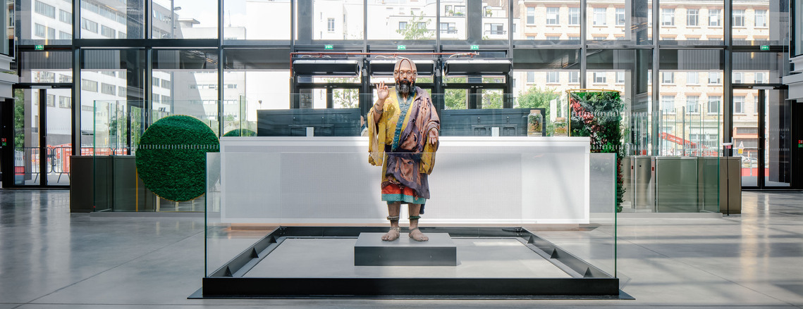 station f, takashi murakami, animated lifesize sculpture, art, glass casing, concrete floor, morning light,
