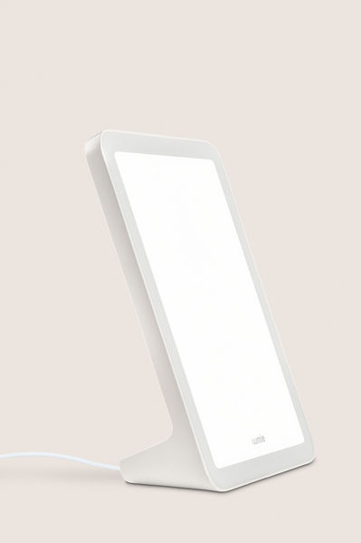 A product shot of a Lumie lamp on a plain back drop. 