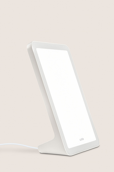 A product shot of a Lumie lamp on a plain back drop. 