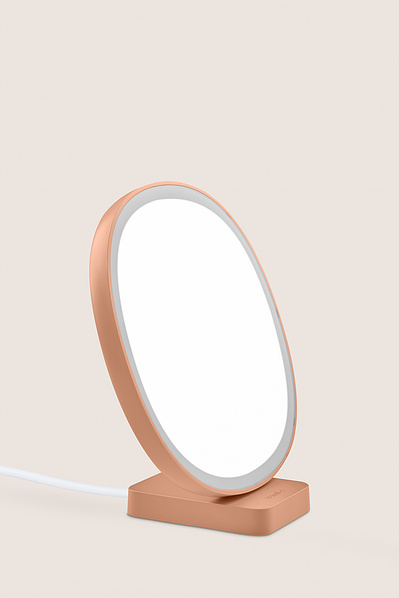 A product shot of a Lumie lamp on a plain back drop. 