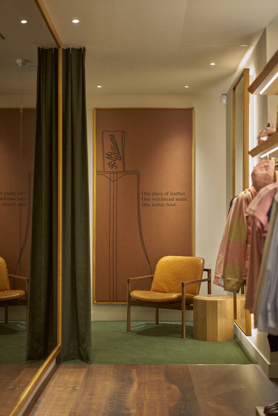 An image of a clothing store with an art piece on the wall