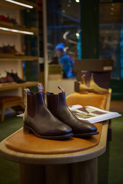 a pair of brown boots sitting on top of a wooden table