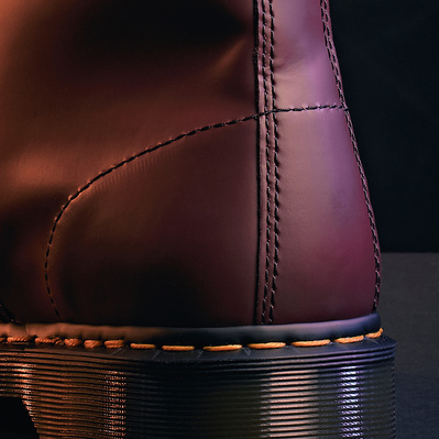 stylish and cinematic close up product shot of a Dr Martens 1460 red boot, focussing on the heel. 