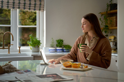 A is having breakfast in the kitchen, illuminated by a Lumie lamp. 