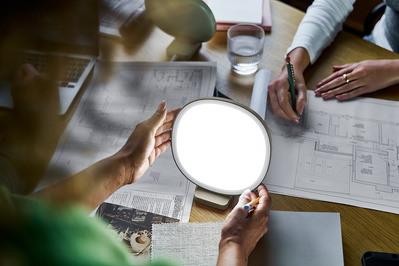 Three architects sit around a desk. 