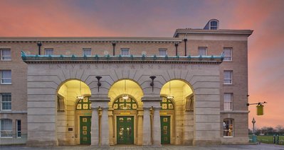 A grandiose hotel entrance on a summers evening. 