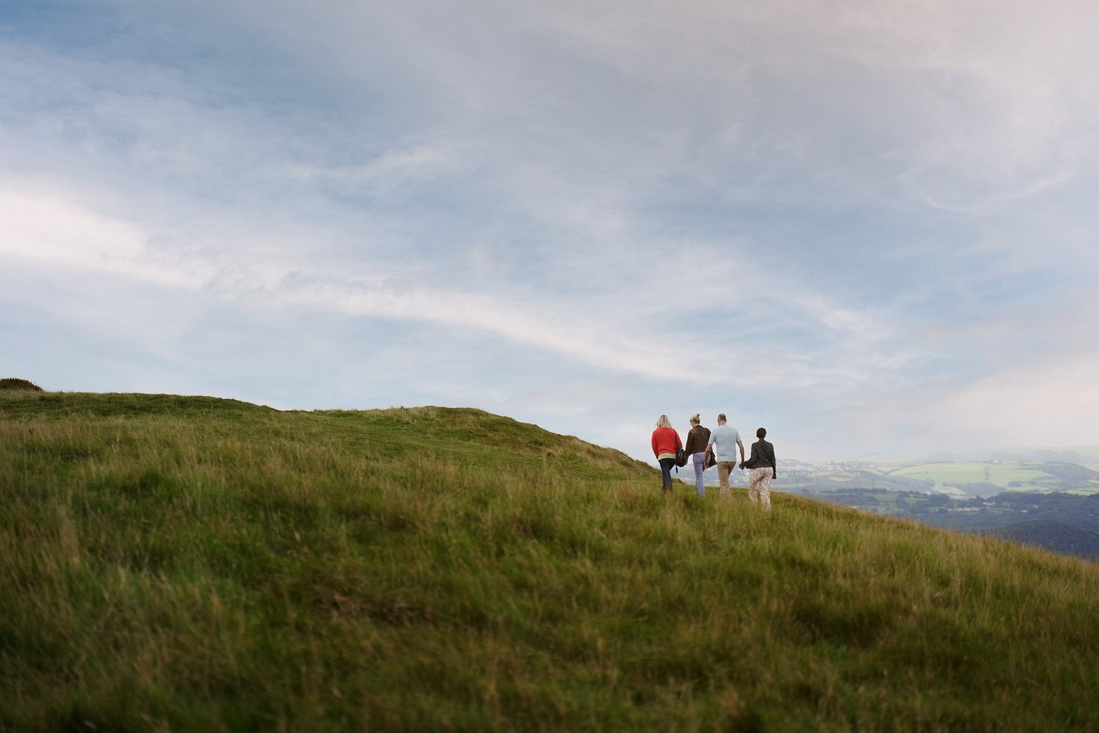 A group of friends walk up a steep hill