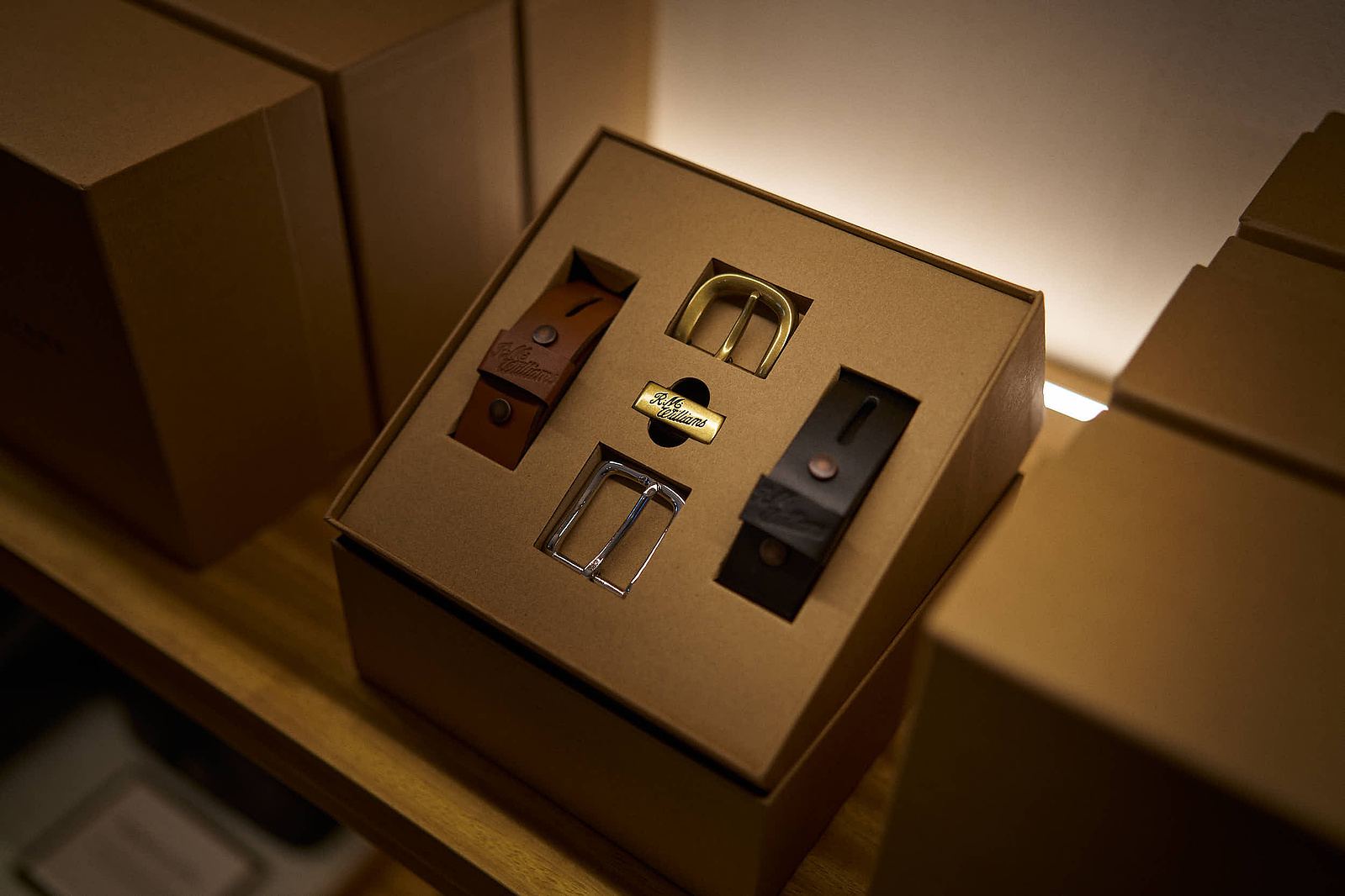 A mens belt gift set on a shelf in a clothing store. 