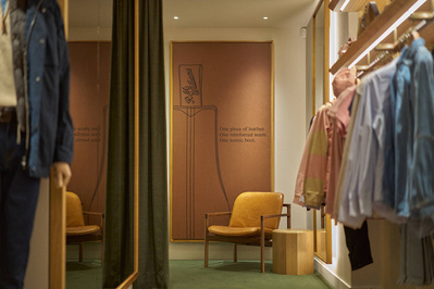 An image of a clothing store with an art piece on the wall