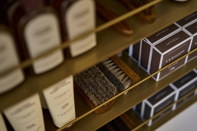 Some leather shoe cleaning products on a shelf. 