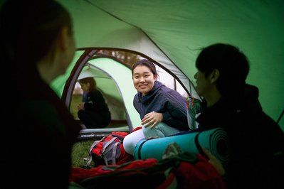 Three people in a camping tent