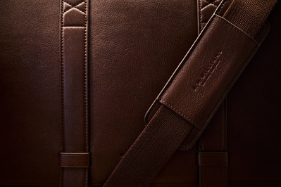 A close up detail shot of the texture on a brown leather bag. 