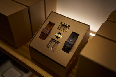 A closeup shot of a leather belt gift set in a menswear shop. 