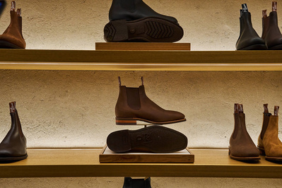 A shelf of shoes in a shoe shop. 