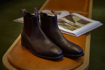a pair of brown boots sitting on top of a wooden table