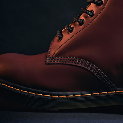 stylish and cinematic close up product shot of a Dr Martens 1460 red boot, focussing on the toe. 