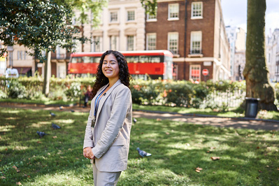 girl posing for portrait in front of a London bus