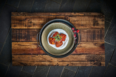 A top down photograph of a meal on a wooden cutting board. 