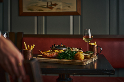A fish platter on a wooden table in a restaurant. 