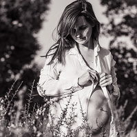 fotografía de barriga de embarazada  de 38 semanas, en los campos floridos de Pla de l'Estany, en girona, españa.