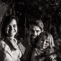 fotografía de una familia ella está embarazada  de 38 semanas, en los campos floridos de Pla de l'Estany, en girona, españa.