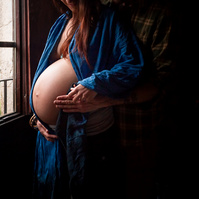 Mujer embarazada se toca el vientre cerca de su ventana en Olot, la garrota
