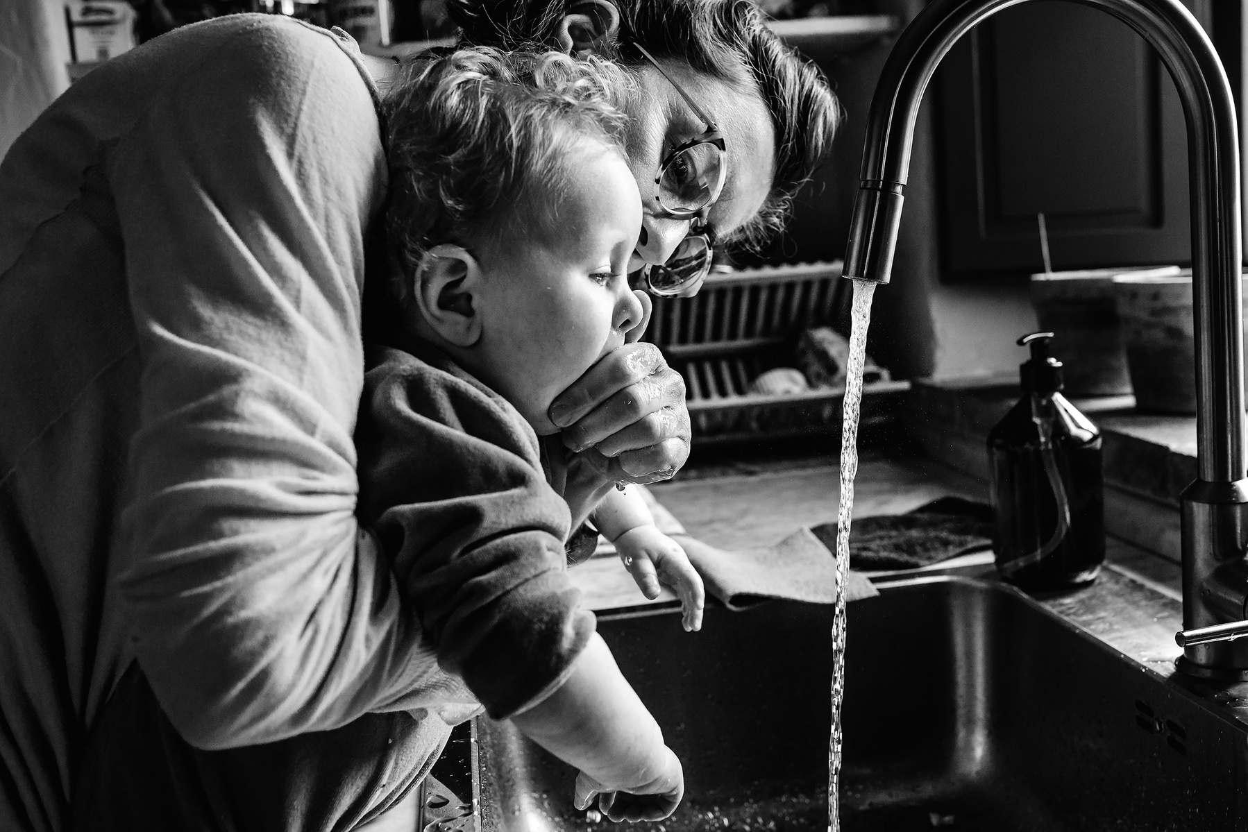 mamá limpiando la boca de su bebé en la cocina, Manuela Franjou