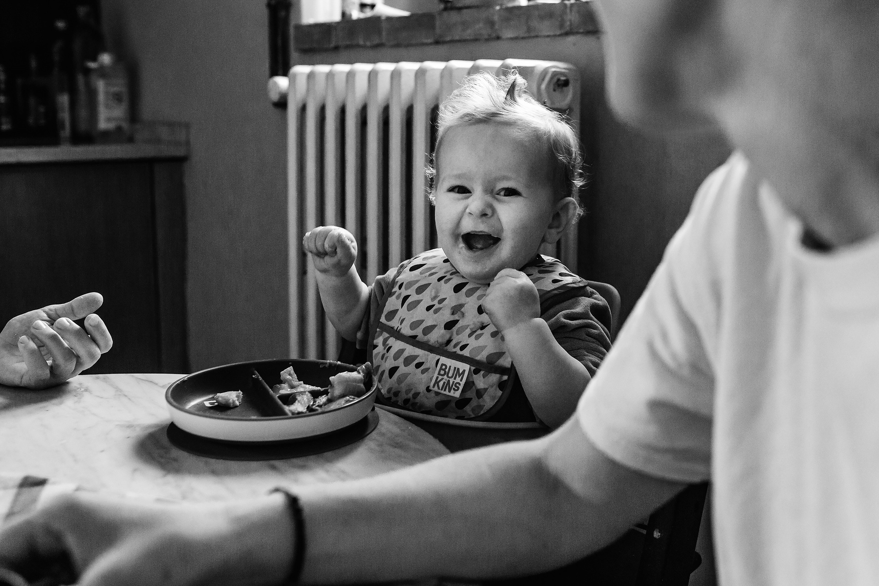 dos mamás compartiendo con su bebé en la mesa de la cocina, Manuela Franjou fotografia de familia