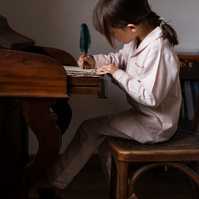 niña escribiendo una carta en un escritorio antiguo,  FW 21-22 pijamas capsule campaign for the kids fashion brand Bachaā  and calisperia at l'empordà, spain