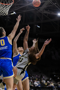 Senior forward Peanut Tuitele (33) falls after shooting the ball during the game against the Washington Huskies on Sunday, Jan. 9th, 2022. (Io Hartman&#x2F;CU Independent)