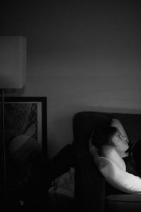 My mother lays on our living room couch under an infrared lamp on September 1st, 2021.