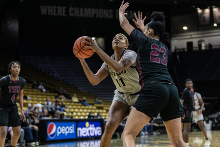 Junior center Quay Miller (11) shoots the ball during the game against TSU on Tuesday, Nov. 23rd, 2021. (Io Hartman&#x2F;CU Independent)