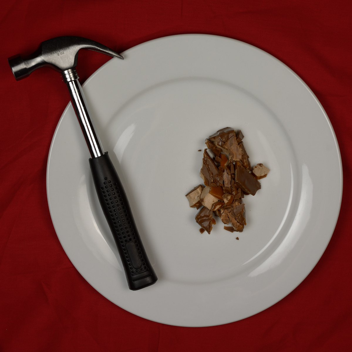 plate containing a hammer and a smashed Mars bar