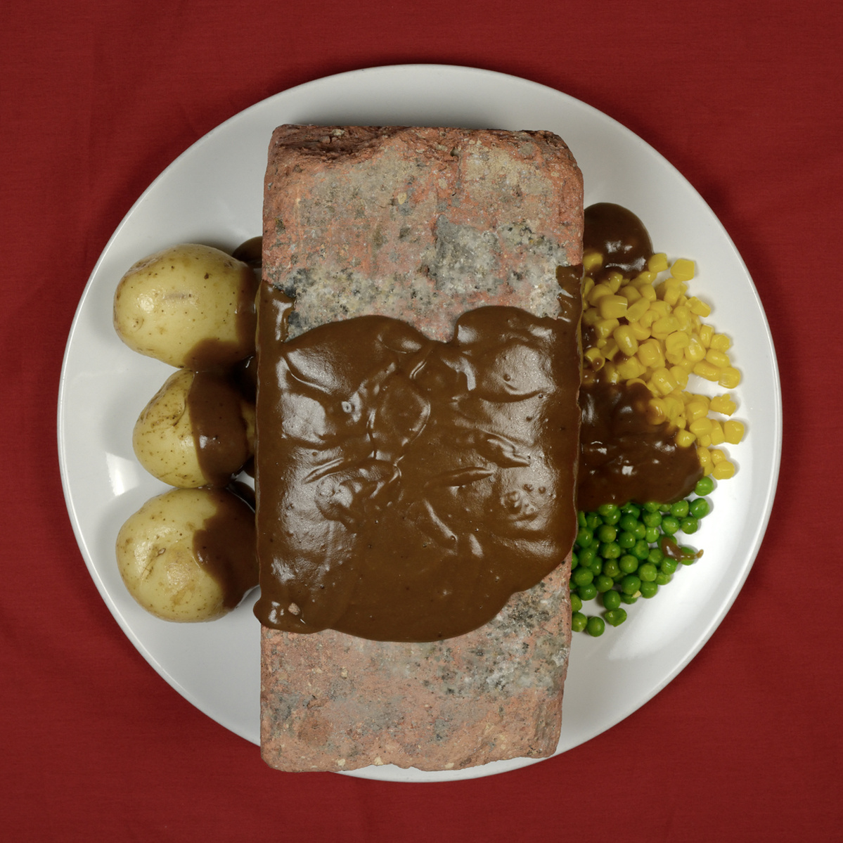 plate containing a building brick served up like a roast dinner