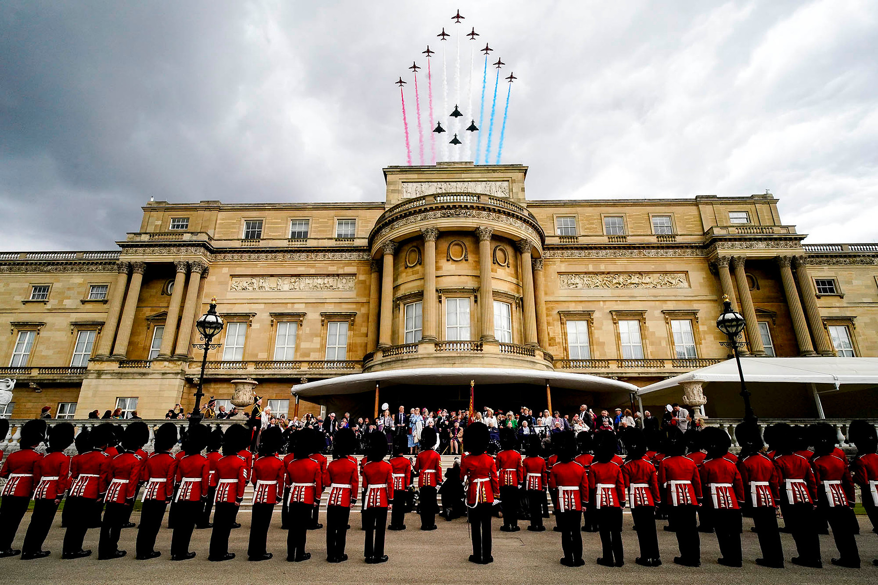 Veterans and members of the armed forces on the West Terrace in the gardens of Buckingham Palace, London, to view the fly past of the Red Arrows on the 80th anniversary of VE Day