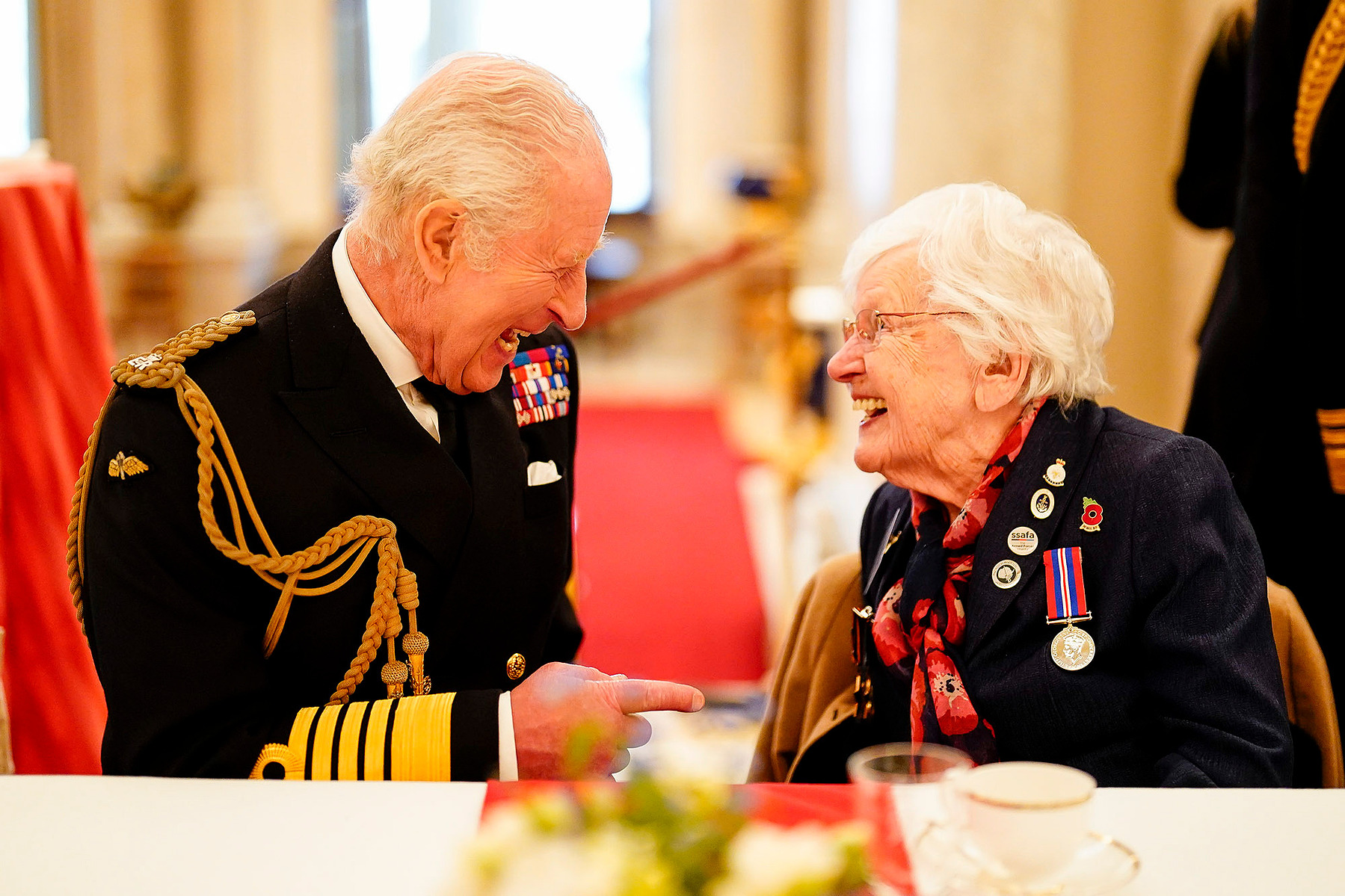 King Charles III joins 101-year-old Second World War veteran Ruth Barnwell at a tea party in Buckingham Palace, central London, following the military procession to mark the 80th anniversary of VE Day.
