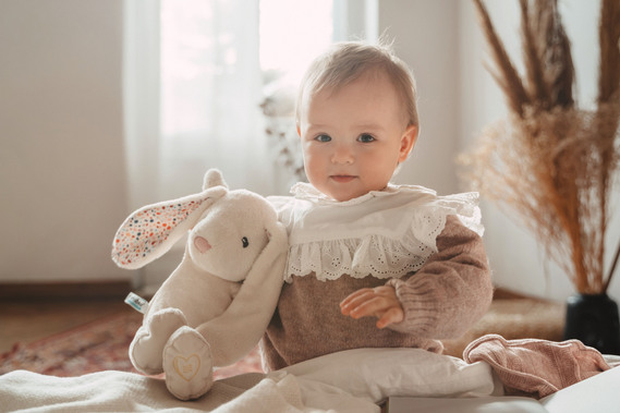 A baby girl with a teddy bear. 