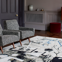 Two grey lounge chairs in an interiors scene photographed for Knots Rugs by Graham Atkins-Hughes