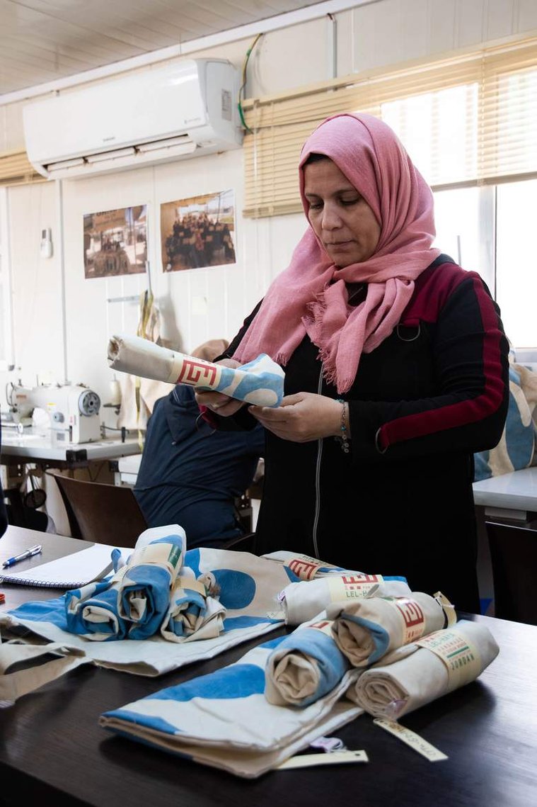 Suha, a Lel-Haya project sewing trainer, works to package the recycled tote bags that will be sold through Oxfam’s partner, Souq Fann. 