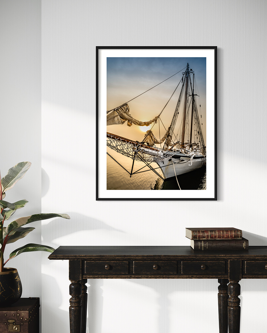 The "Spirit of South Carolina", a tall sailboat, docked in the Charleston Harbor at sunrise.