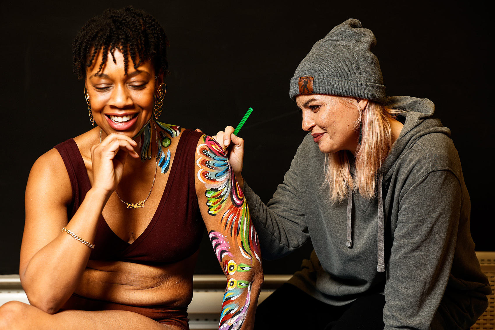  Body painting artist Melissa Brant paints on volunteer Chantal Carter’s body in her art studio. Brant studied to become a makeup artist before becoming a body painting artist. 