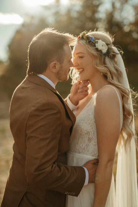 Groom sweetly touching Bride's face on wedding day.