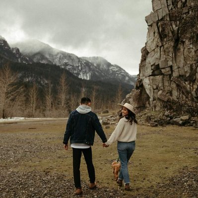 A couple holds hand on a foggy day in the Columbia River Gorge for their engagement photos.