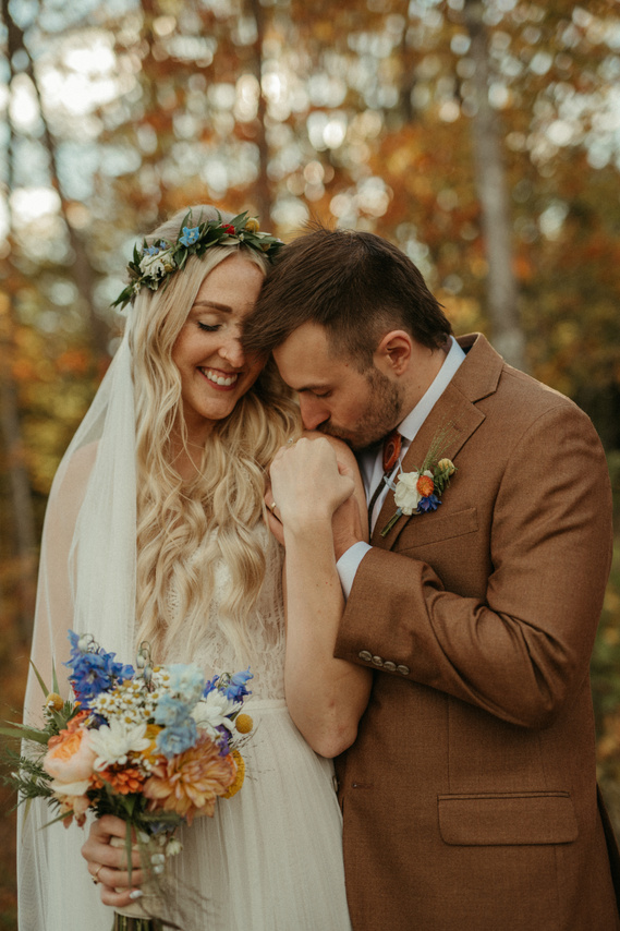 Husband kissing Wife's shoulder on wedding day in Minnesota
