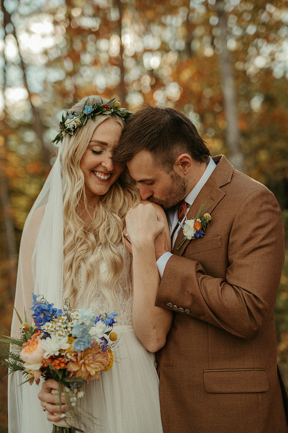 Husband kissing Wife's shoulder on wedding day in Minnesota