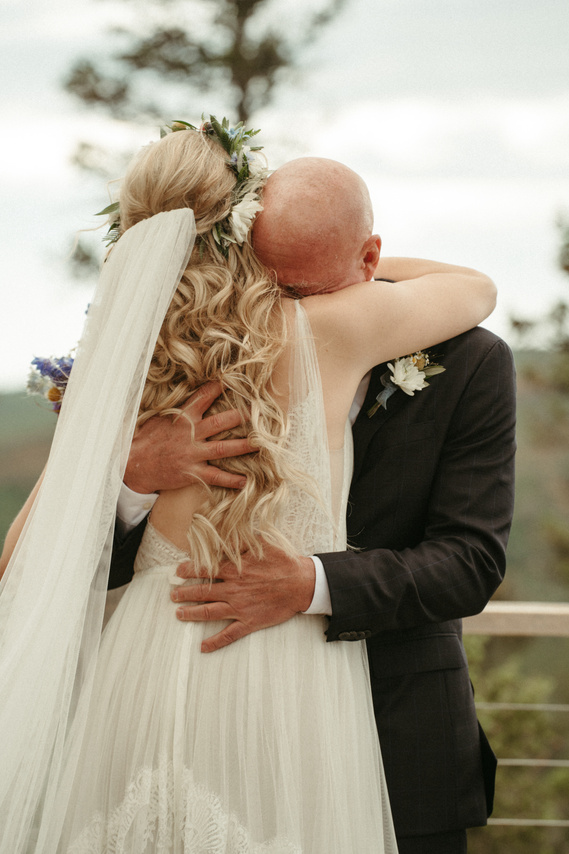 Father and Daughter hugging on her wedding day.