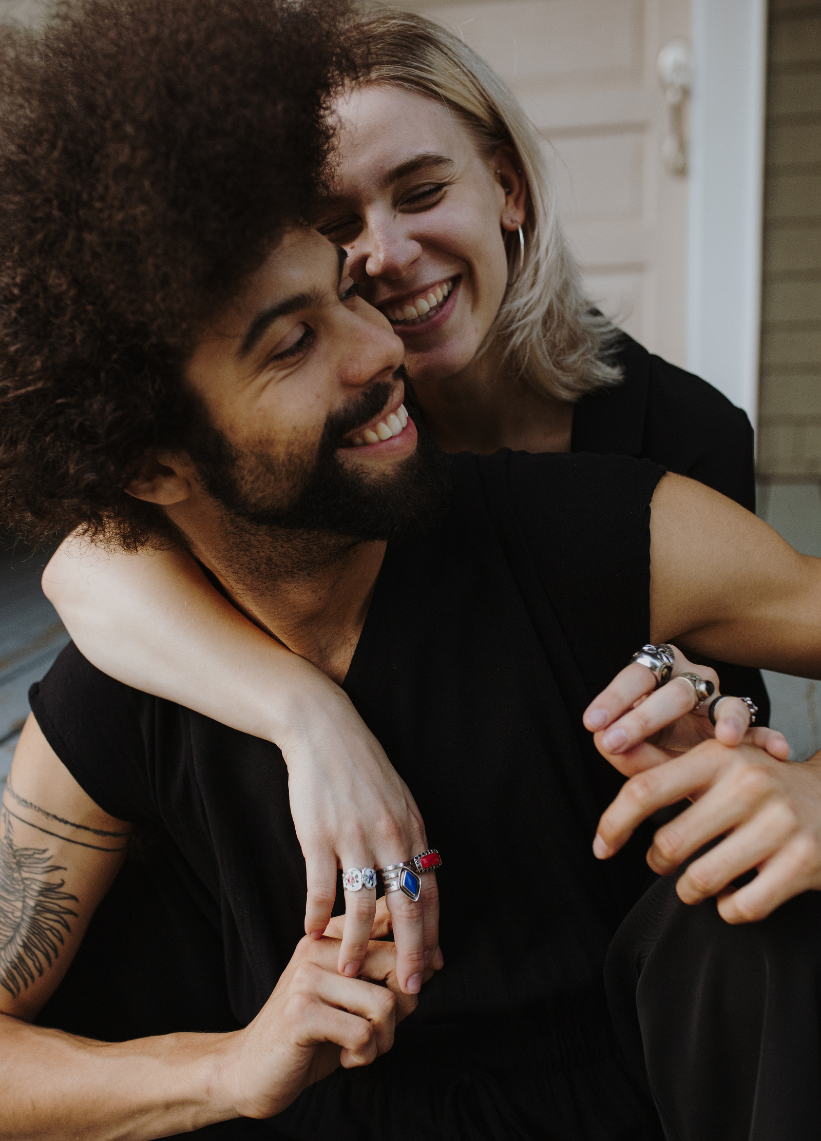 An edgy couple snuggles on their front porch for an editorial style photoshoot in Portland Oregon.