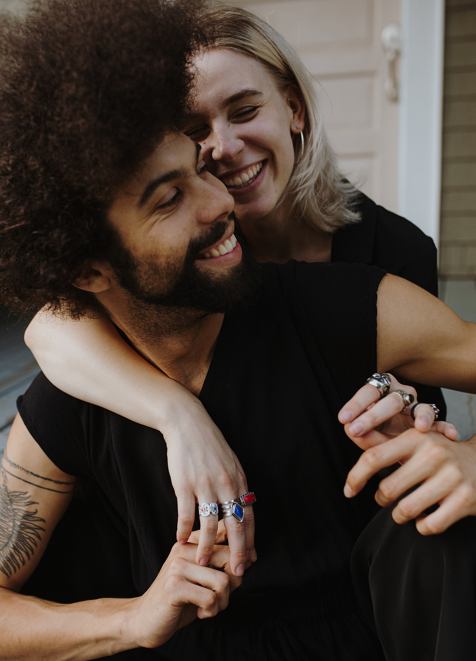 An edgy couple snuggles on their front porch for an editorial style photoshoot in Portland Oregon.